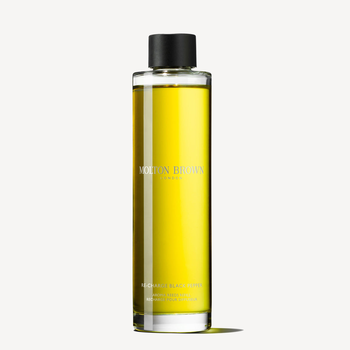 A bottle of MoltonBrown Cyprus Re-charge Black Pepper Aroma Reeds Refill 150ml is elegantly displayed against a plain white background, showcasing the yellow liquid with a black cap and minimalist label, exuding spicy, earthy tones with hints of woody-citrus allure.