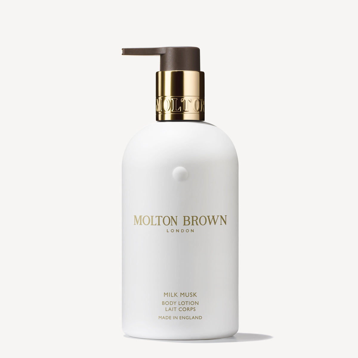 The Milk Musk Body Lotion 300ml from MoltonBrown Cyprus features soothing milk and creamy musk in a sleek white bottle with a pump dispenser and silver accents. The elegant font on the label highlights the brand name and product details, adding a touch of luxury.