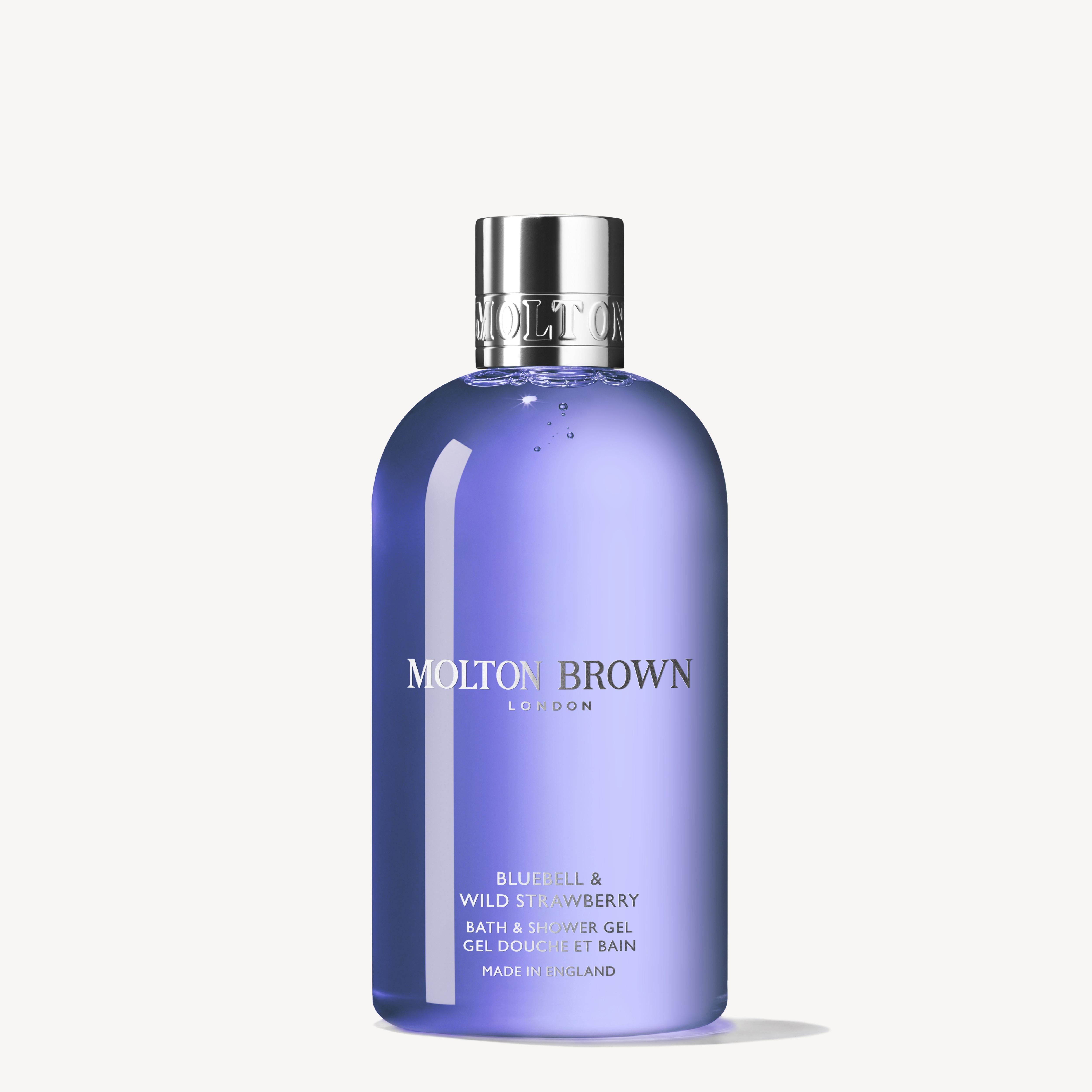 The MoltonBrown Cyprus Bluebell & Wild Strawberry Bath & Shower Gel 300ml offers a floral-fruity body wash experience, captured in a translucent purple bottle with a shiny silver cap and white text, evoking the essence of wild strawberries in fresh spring woodland air.
