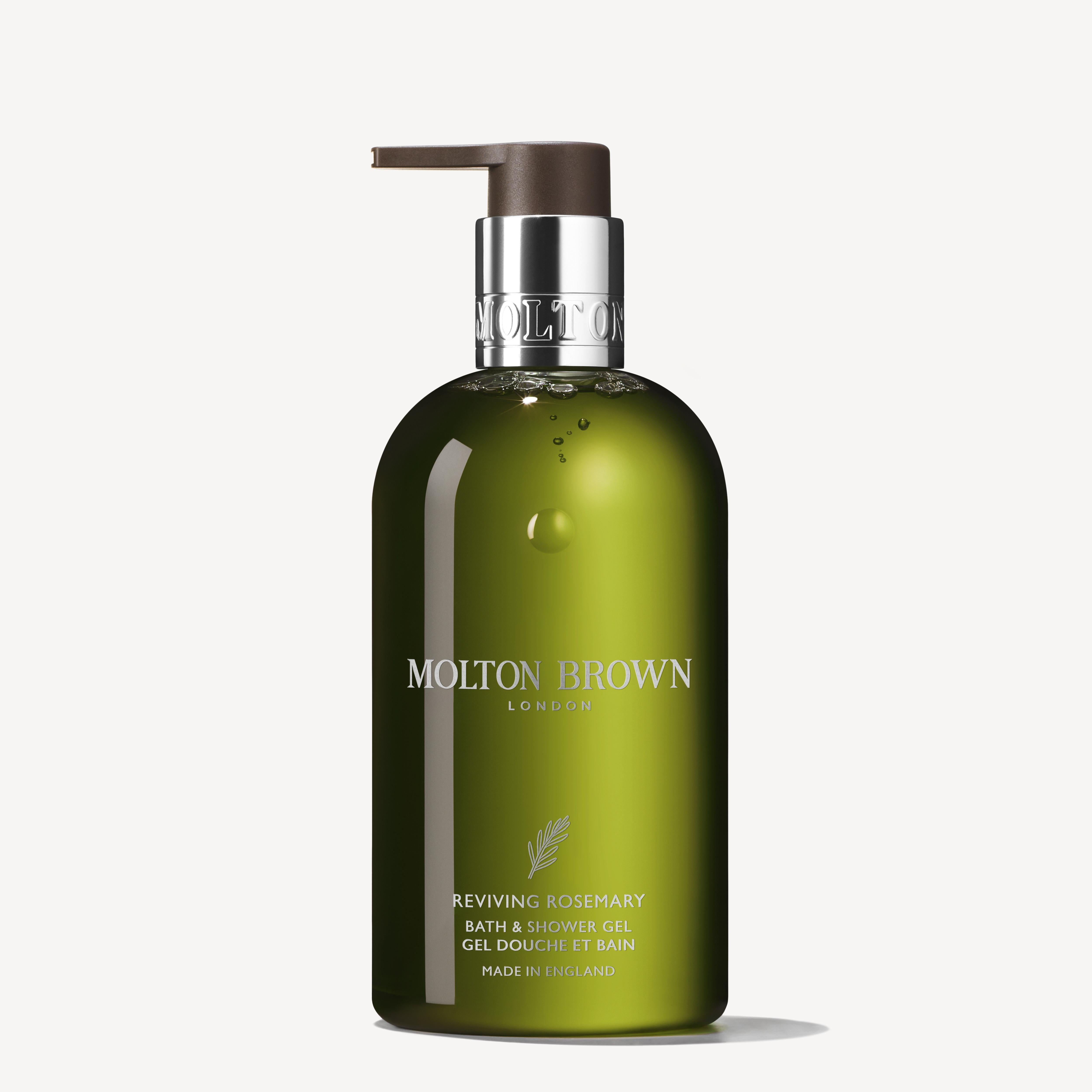A green 300ml bottle of MoltonBrown Cyprus Reviving Rosemary Bath & Shower Oil-In-Gel with a brown pump rests on a white background. Its label, featuring silver text and an emblem, assures a luxurious milky lather for your body wash routine.