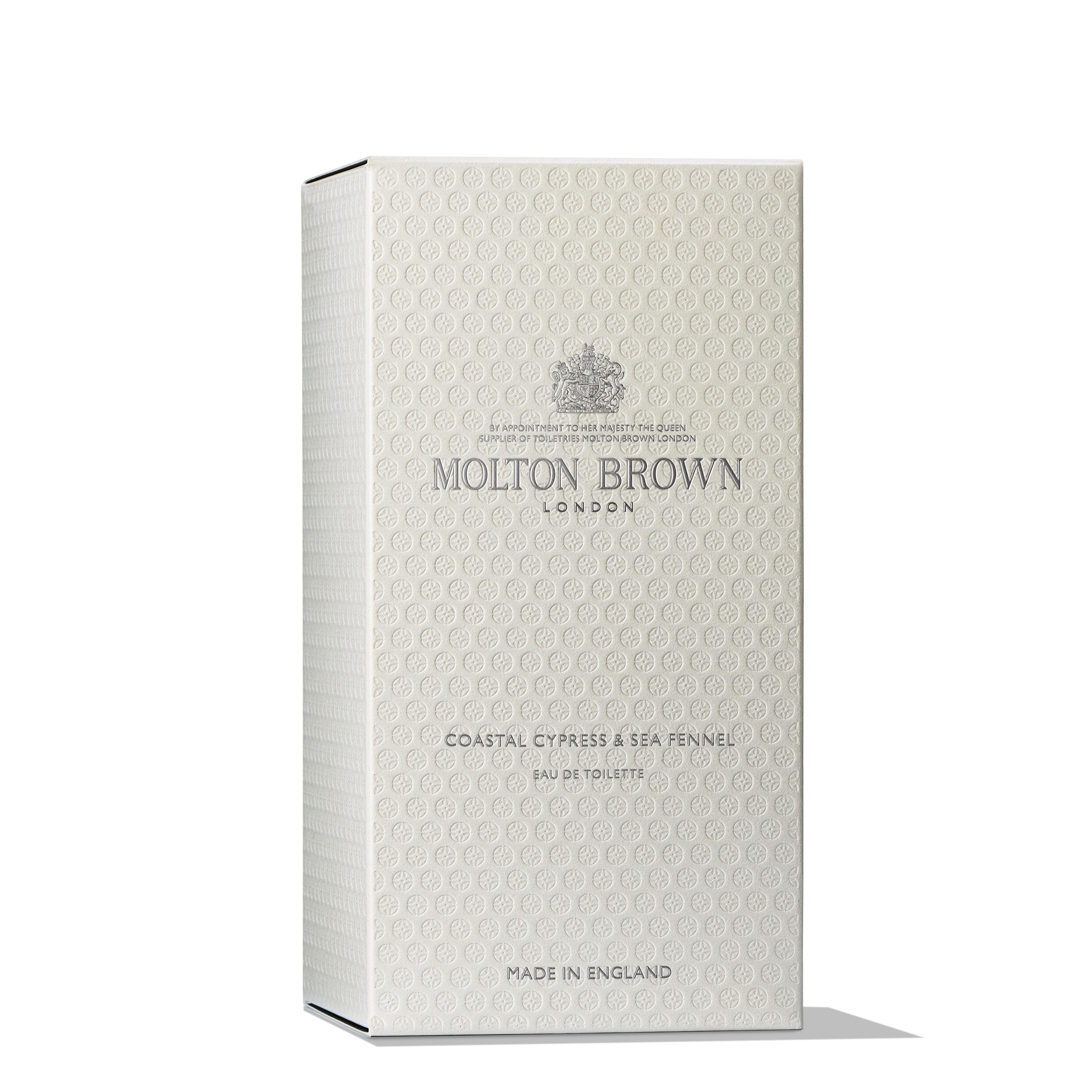 The image features a MoltonBrown Cyprus box in beige, labeled Coastal Cypress & Sea Fennel Eau de Toilette 100ml. It is adorned with the classic logo and embossed patterns, exuding elegance and cedarwood sophistication. Crafted in England, it epitomizes refined branding.