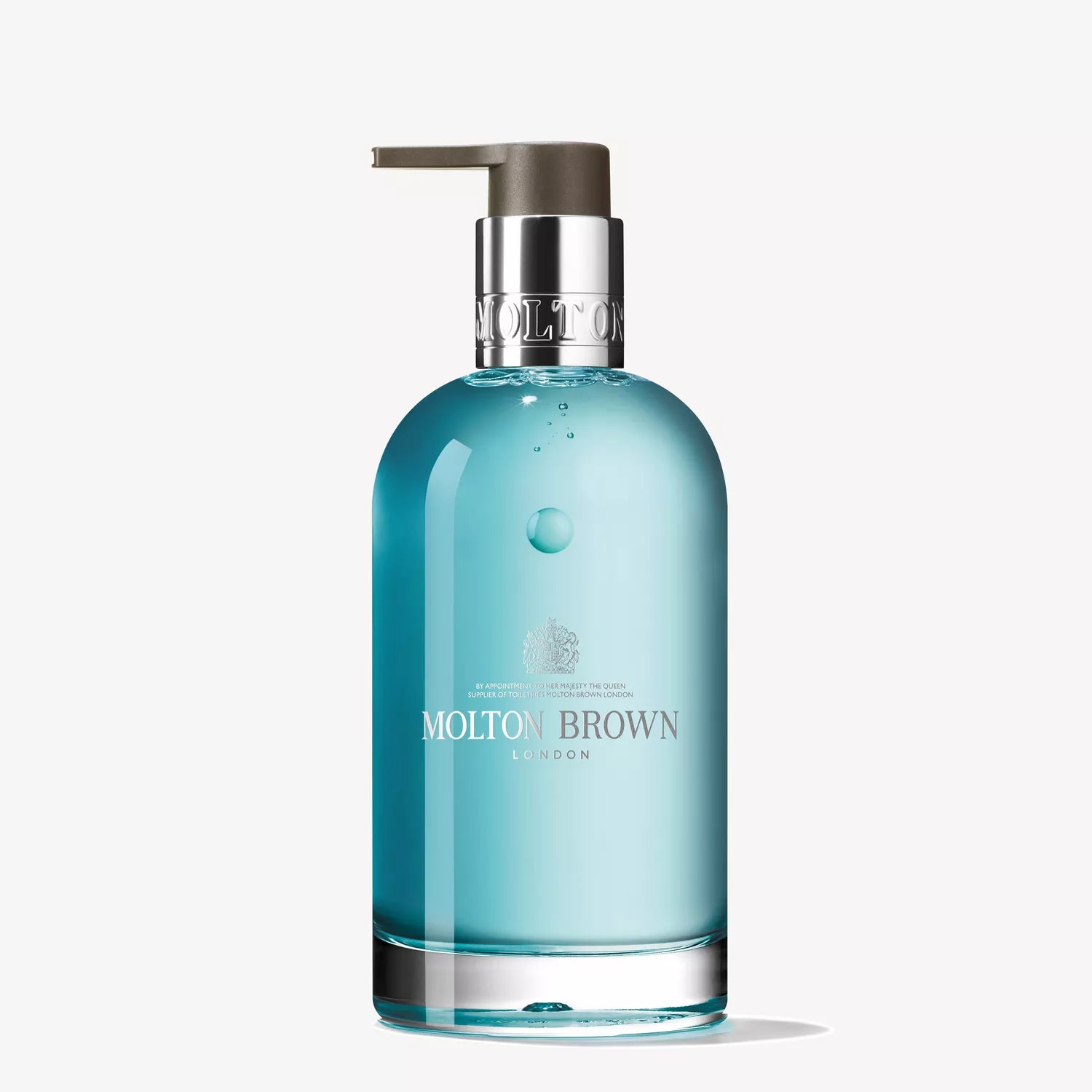 A clear blue glass bottle of Molton Brown Cyprus Coastal Cypress & Sea Fennel hand wash, featuring a silver cap and pump on a white background. The label showcases the brand name and logo in white text.