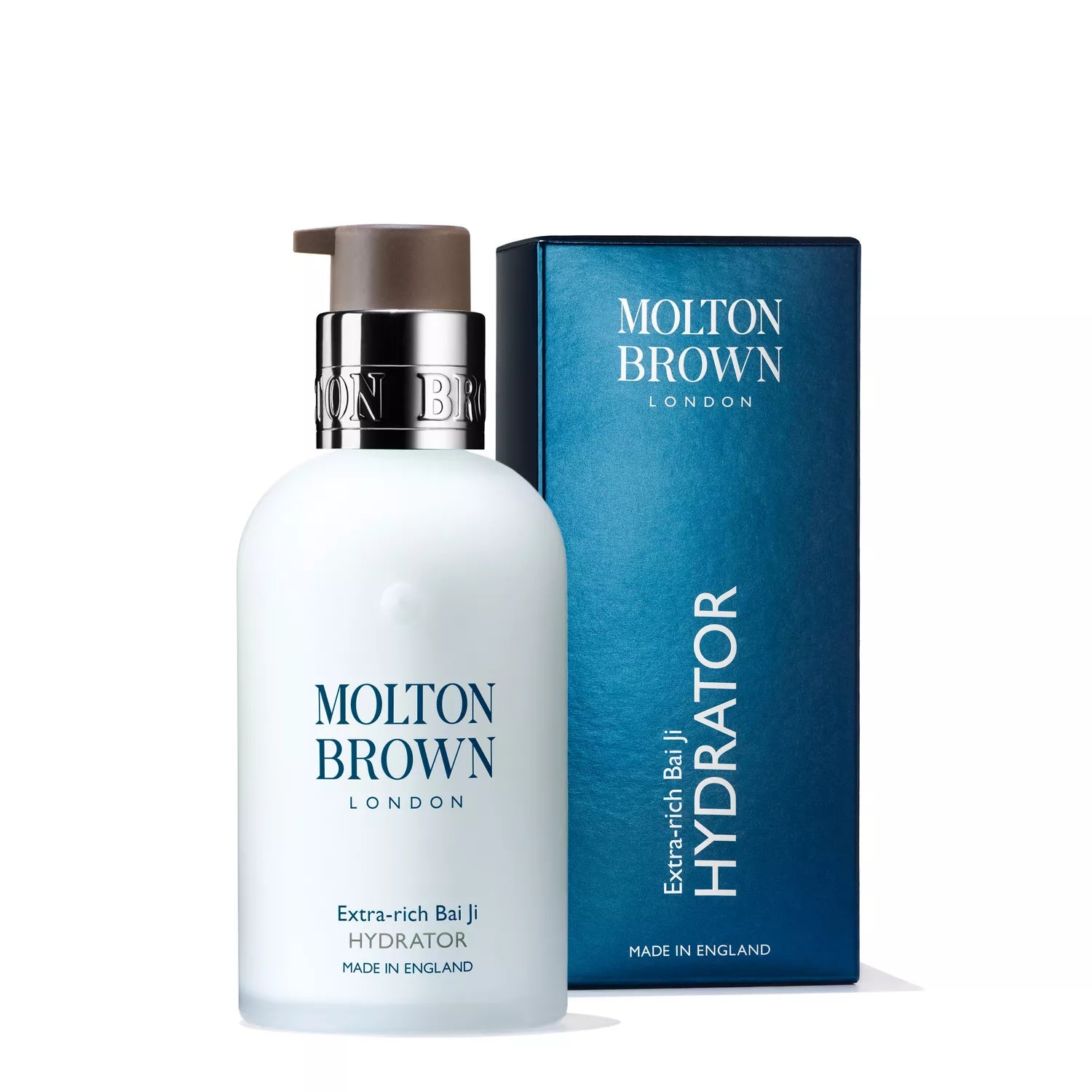 A white pump bottle labeled Molton Brown Cyprus Extra-rich Bai Ji Hydrator 100ml with a silver top is in front of a dark blue box. It offers rich moisturizing benefits from bai ji extract to keep your skin luxuriously hydrated and soft.