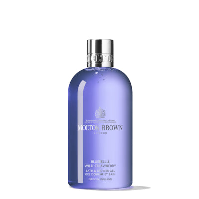 The MoltonBrown Cyprus Bluebell & Wild Strawberry Bath & Shower Gel 300ml offers a floral-fruity body wash experience, captured in a translucent purple bottle with a shiny silver cap and white text, evoking the essence of wild strawberries in fresh spring woodland air.