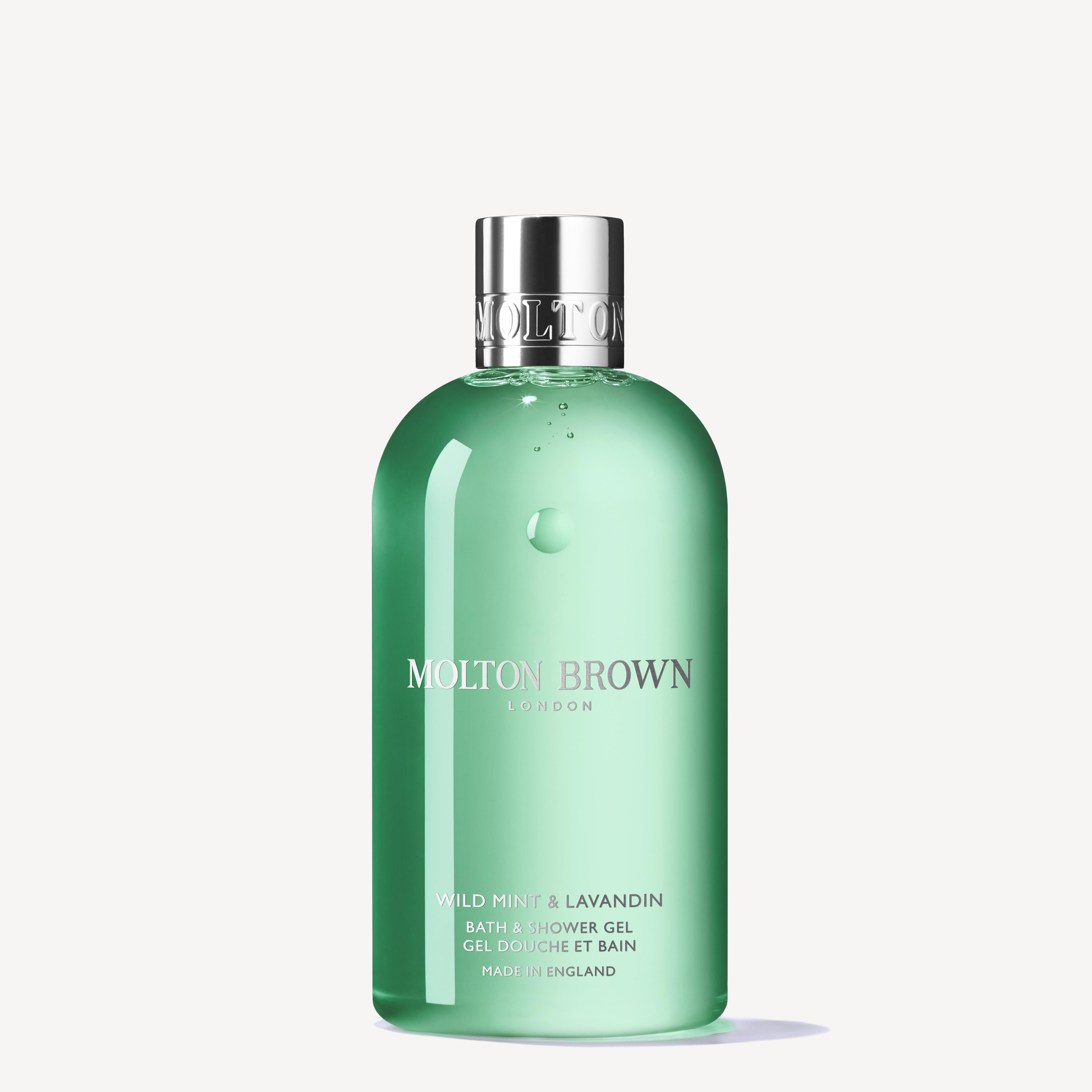 A 300ml bottle of MoltonBrown Cyprus Wild Mint & Lavandin Bath & Shower Gel features an infusion of wild mint, lavandin, and orris root. The gel is green, topped with a silver cap, and showcases elegantly printed product details on the front.